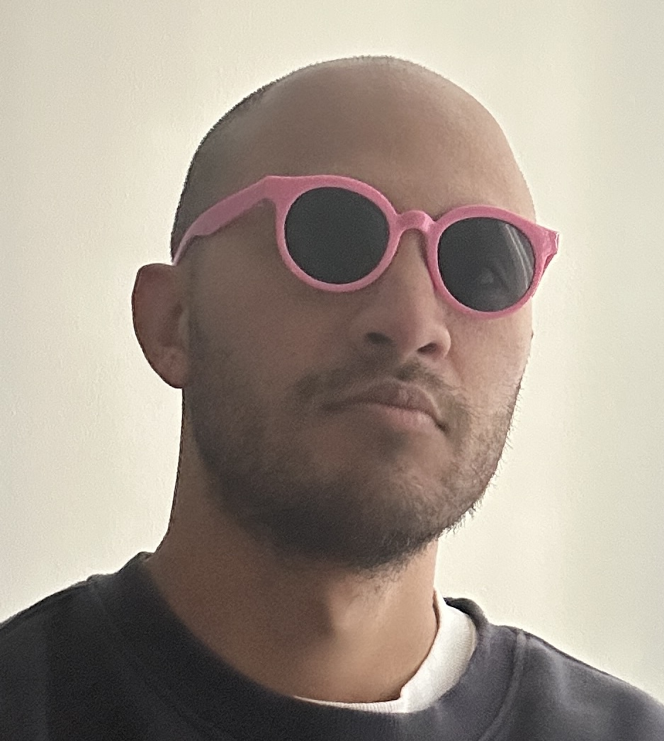 christian ventura wearing round pink glasses